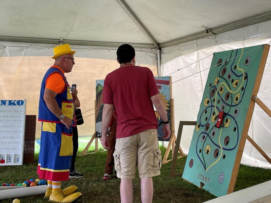 Lewy demonstrating a children's activity at a fair